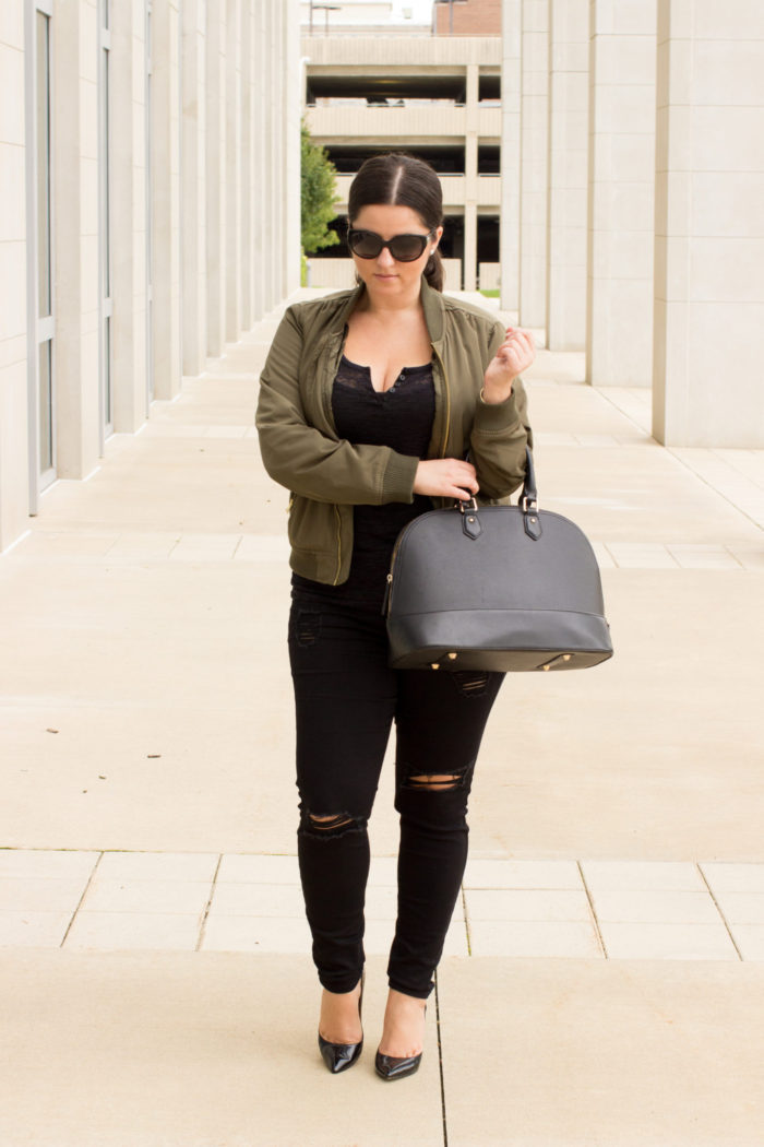kim kardashian inspired outfit, green bomber jacket, black distressed jeans, black top, black satchel,
