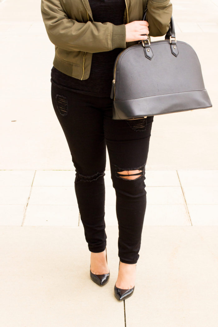 kim kardashian inspired outfit, green bomber jacket, black distressed jeans, black top, black satchel,