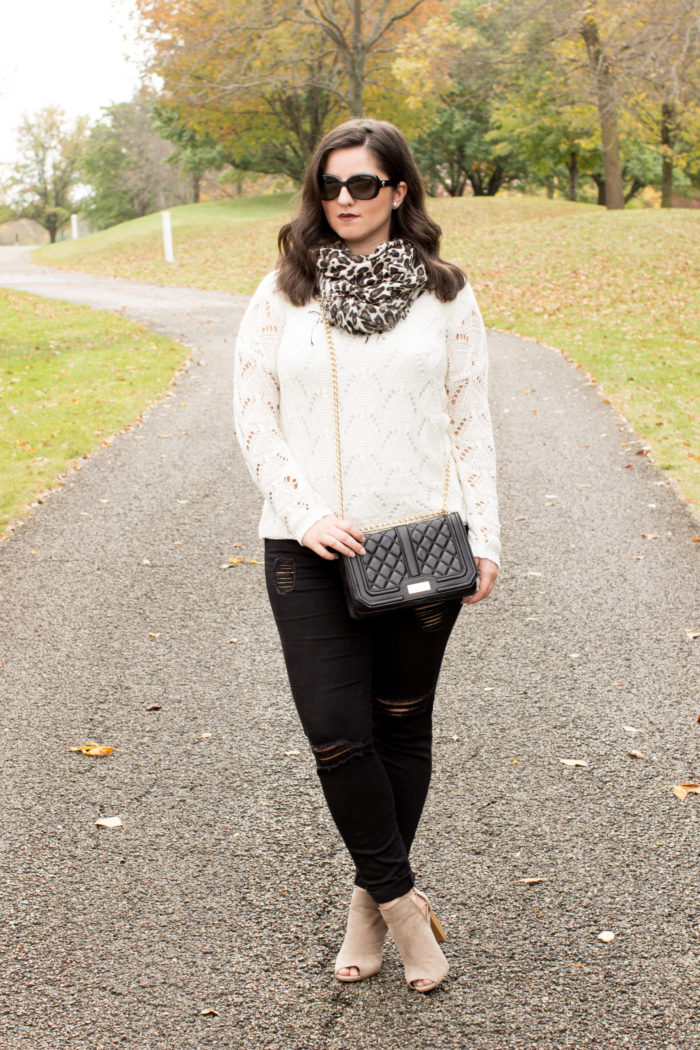 accessorizing with a leopard scarf, black skinny jeans, off white sweater,