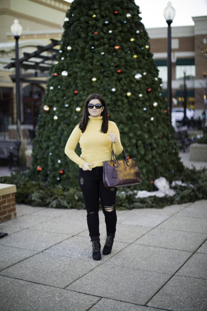 casual winter outfit with a yellow sweater, mustered yellow turtle neck sweater, black ripped jeans, black distressed skinny jeans, CAT wedge booties, ralph lauren satchel