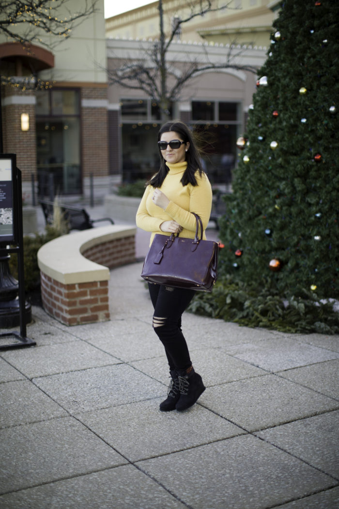 casual winter outfit with a yellow sweater, mustered yellow turtle neck sweater, black ripped jeans, black distressed skinny jeans, CAT wedge booties, ralph lauren satchel